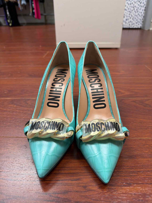 Teal Moschino croc print heels