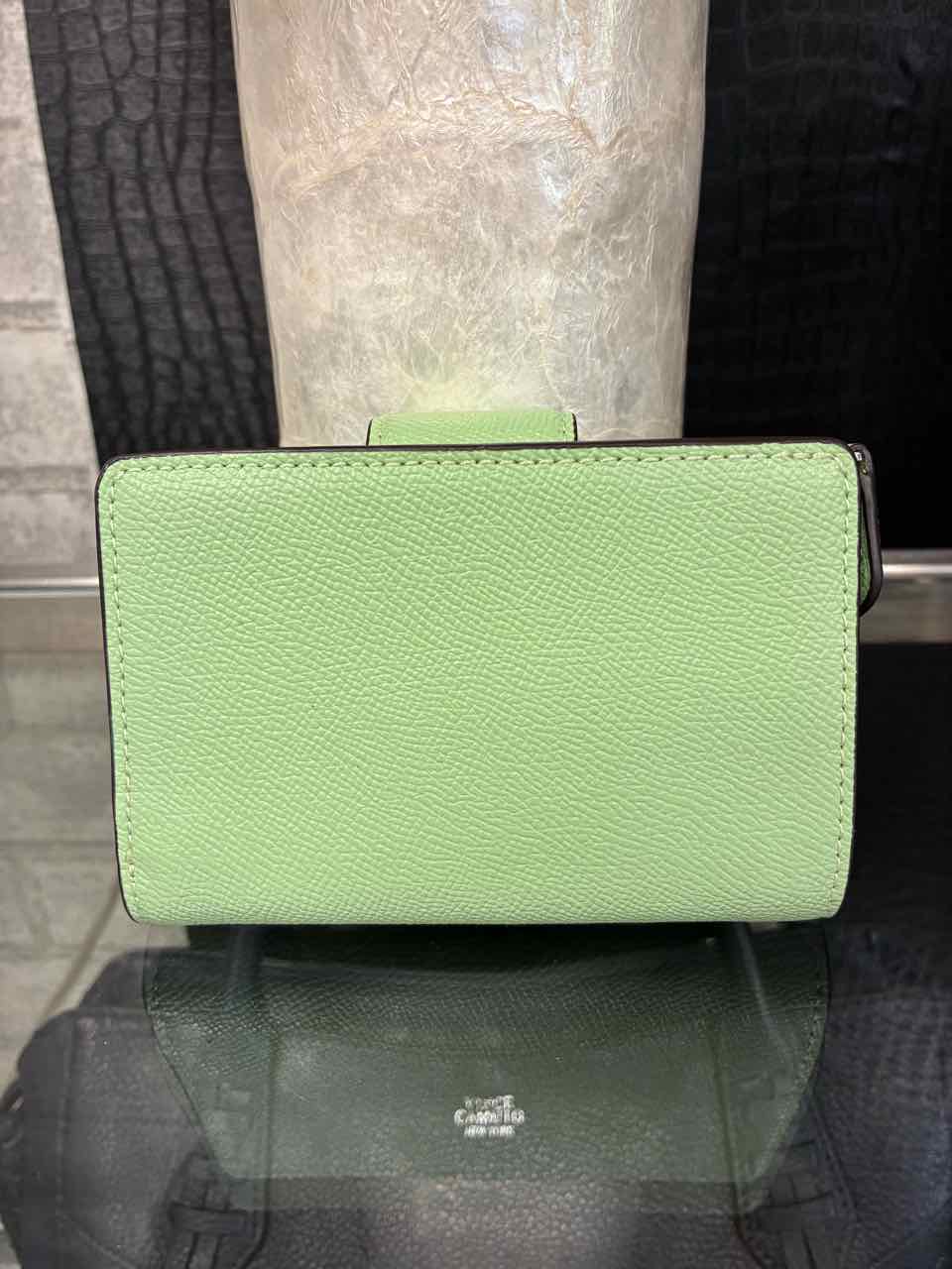 Coach Pistachio/green medium corner zip wallet in crossgrain leather.