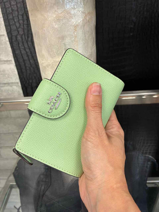 Coach Pistachio/green medium corner zip wallet in crossgrain leather.
