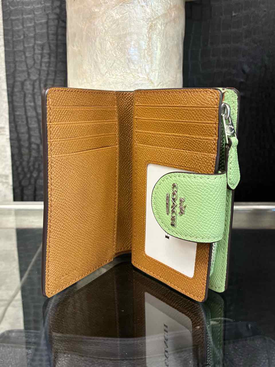 Coach Pistachio/green medium corner zip wallet in crossgrain leather.