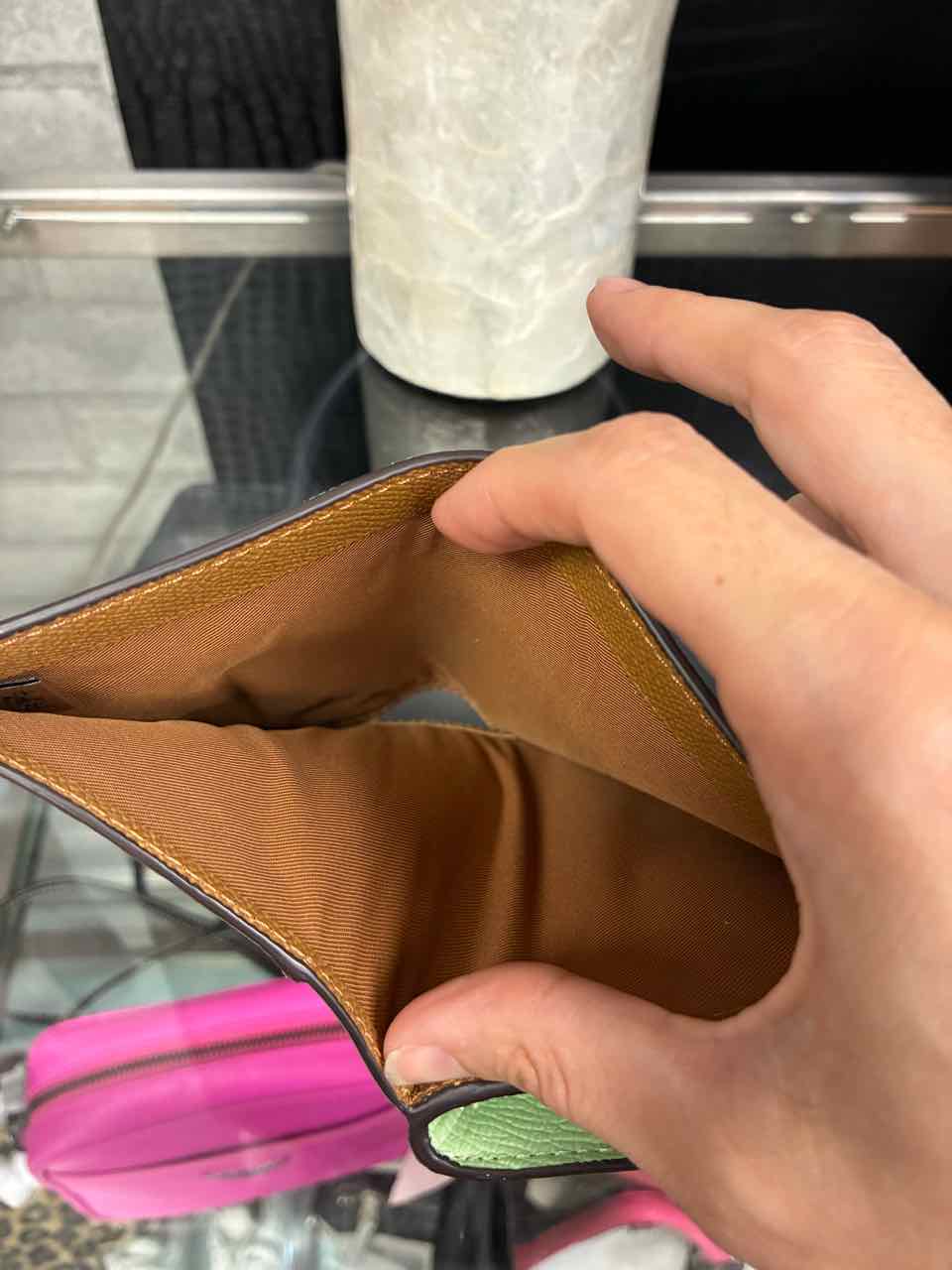 Coach Pistachio/green medium corner zip wallet in crossgrain leather.