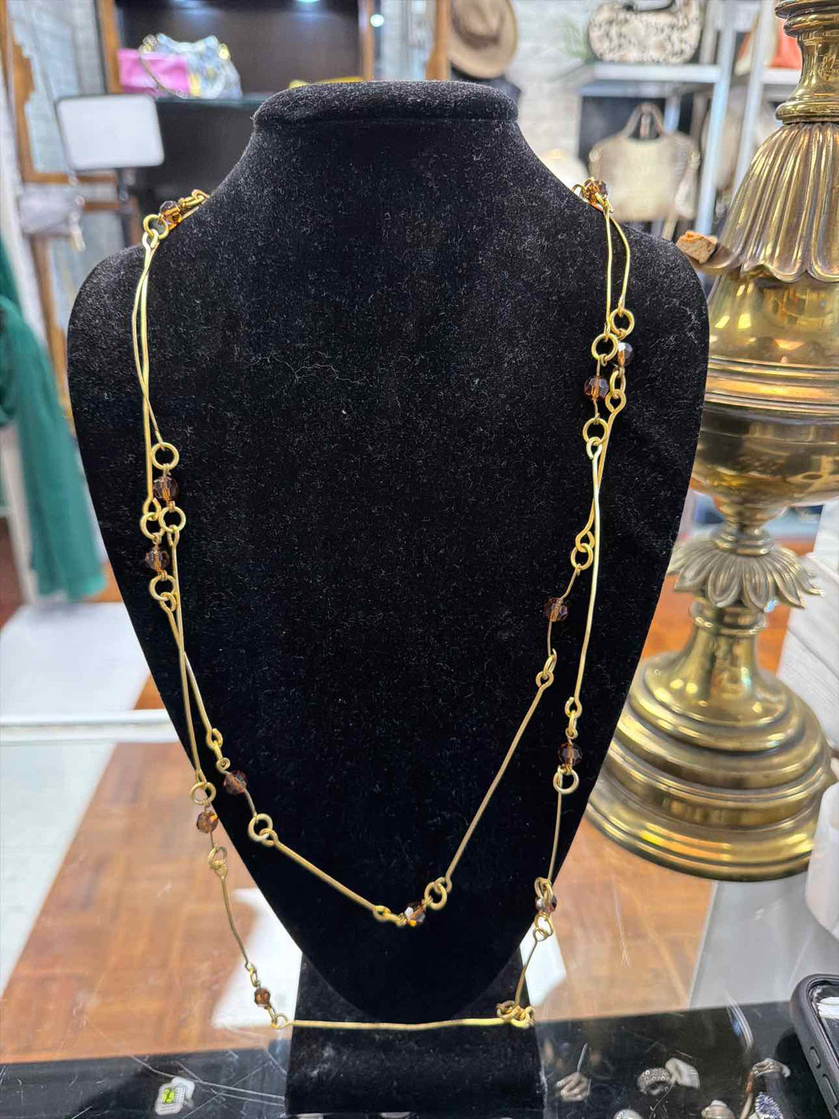 Gold necklace with brown beads and long