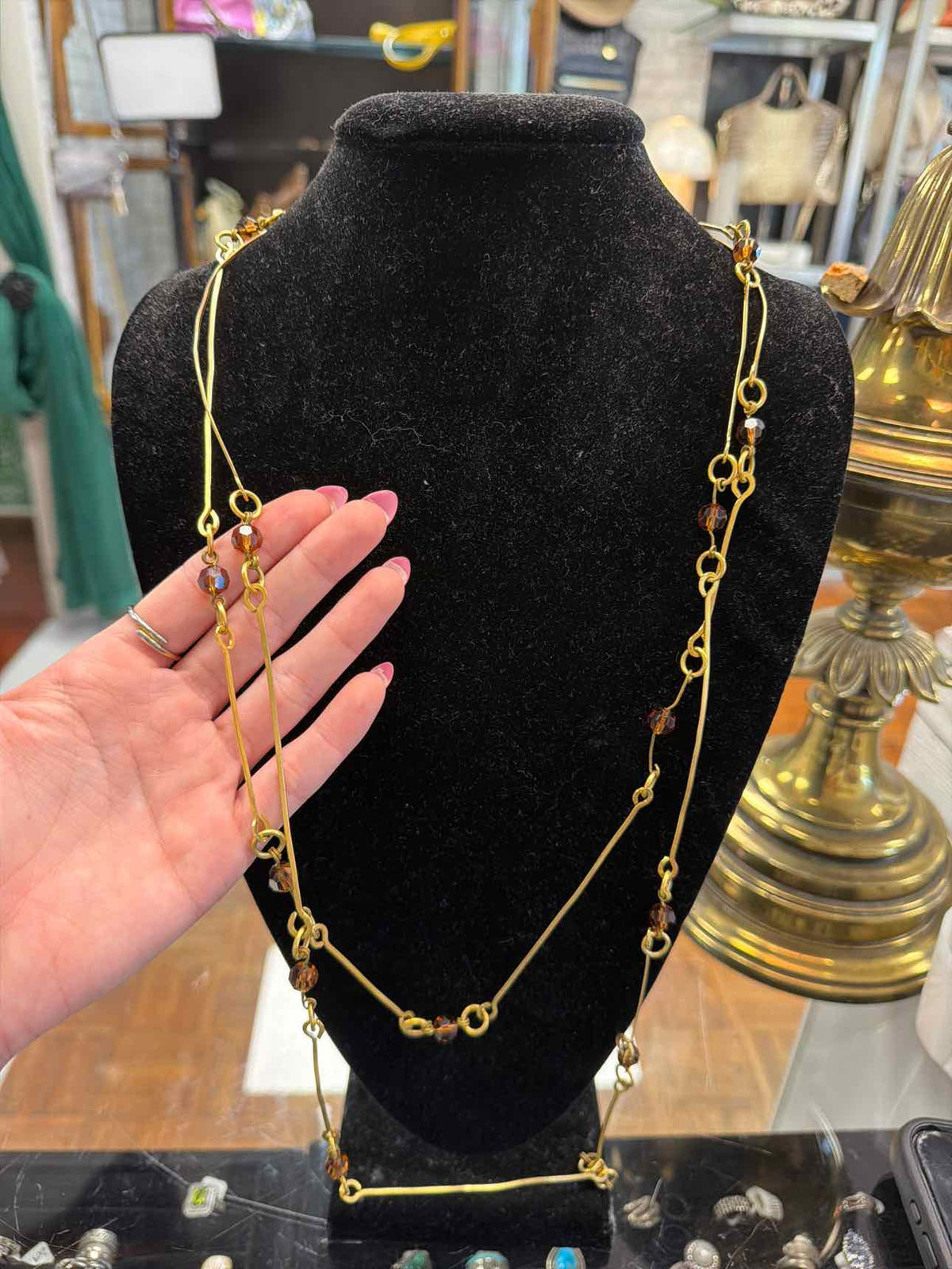Gold necklace with brown beads and long