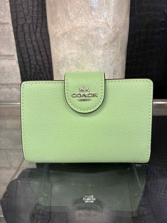 Coach Pistachio/green medium corner zip wallet in crossgrain leather.