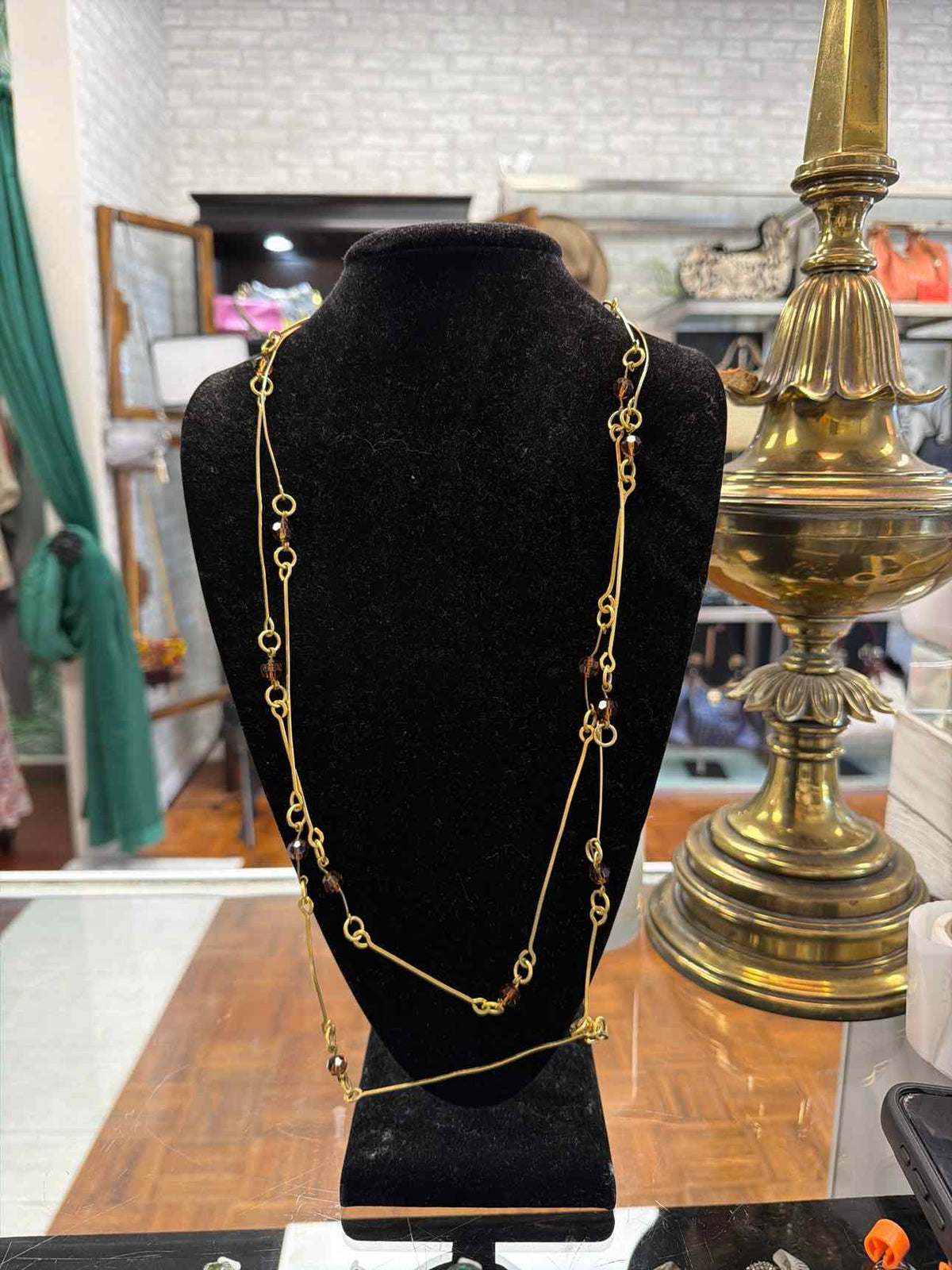 Gold necklace with brown beads and long